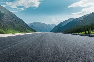 Tuinposter Straight asphalt road and mountain under blue sky. Highway and mountain background. © ABCDstock