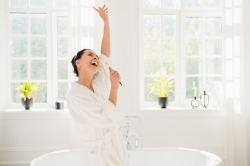Relaxed caucasian mature middle-aged woman in turban after taking shower bath in spa bathroom...
