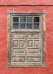 Traditional colonial house with red facade and wooden window. Historic town of Garachico. Tenerife Island. Canary Islands. Spain. 