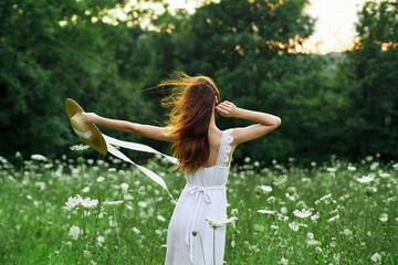 Obraz premium pretty woman in a field in nature white dress fresh air