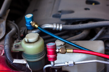 Servicing car air conditioner in vehicle service or repair workshop close-up