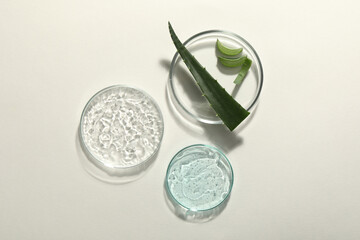 Flat lay composition with cosmetic gel and aloe on white background
