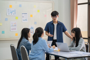 Confident young male professor explaining students.