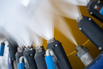 Snowmaking machine (gun) spaying water.