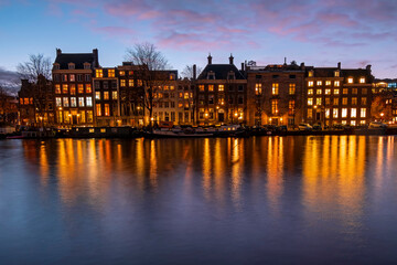 Fototapeta premium City scenic from Amsterdam at the Amsteldijk in the Netherlands at sunset