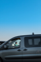 Fototapeta na wymiar man traveler sitting near car at roadside of speedway at sunset