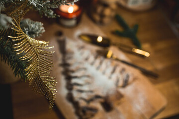 New Year's table. Treats for guests. Puff pastry cake with chocolate in the form of a Christmas tree on a wooden background. The concept of a family holiday. A copy of the space for the text.