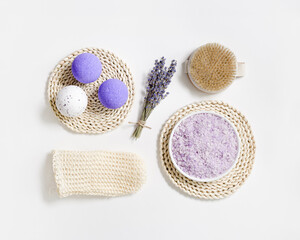 Natural lavender bath bombs and sea salt with essential oil, dried lavender flowers. Exfoliating loofah sponge, massaging brush for body treatment, health and self-care, aromatherapy