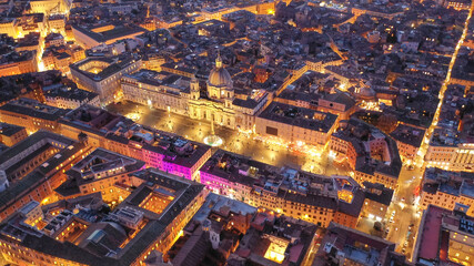 Aerial drone night shot of iconic masterpiece elliptic square - Piazza Navona, Rome historic centre, Italy