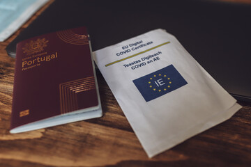 December 5, 2021, Cork, Ireland - A Portuguese passport and an EU digital covid certificate lying on a wooden table