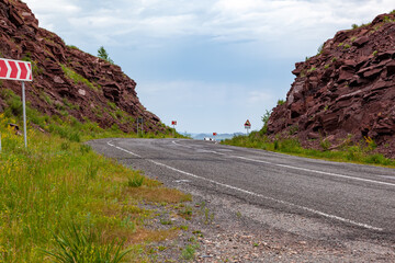 Right Turn Sign: traffic signs warn of a sharp turn on a narrow road.