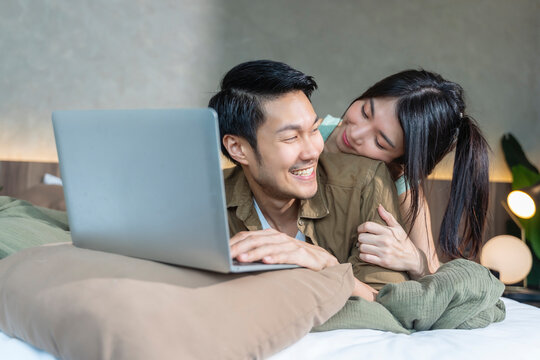 happiness asian people couple working at home with cheerful and happiness hugging together with love and joyful,asian marry couple working with tablet in bedroom at home with hug support husband