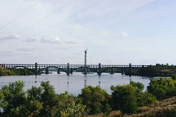 Ukraine, Zaporozhye. View of the blue Dnieper river with rocks, green hills. Khortytsya Island. Center of Ukrainian Cossacks. Dam Dneproges. 