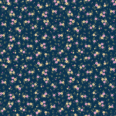 Beautiful floral pattern in small abstract flowers. Small pink and yellow flowers. Dark Blue background. Ditsy print. Floral seamless background. The elegant the template for fashion prints. Stock.