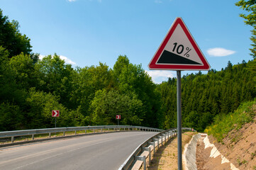 highways in the mountains against the background of the sunny sky and the white clouds