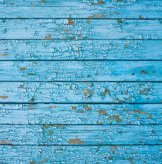 Wooden surface with cracked blue paint
