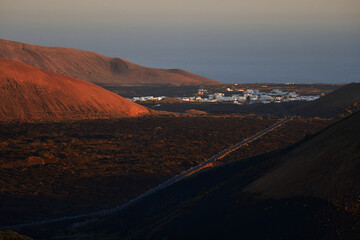 A volcanic landscape with the small town Mancha Blanca in Lanzarote in the morning light.