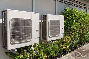 Air conditioner compressor installed in old building. Outdoor split wall type air conditioner...