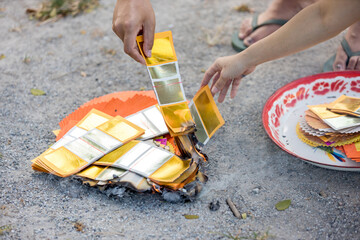 Chinses New Year. Burned paper money, gold paper. Burning the silver and gold fake money paper for...