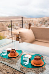 Fototapeta na wymiar Cup with traditional Turkish coffee on a background of a valley in Cappadocia, Turkey.