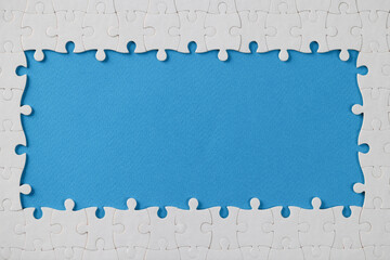 White puzzle frame with missing pieces in middle, empty space in centre