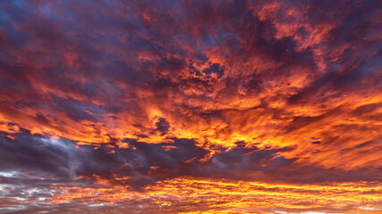 Colorful cloudy sky at sunset. Dramatic sunset sky with clouds. Sky texture, nature background.