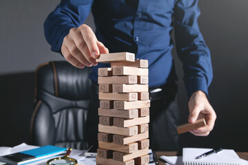  Man stacking a wooden blocks. Business. Plan. Strategy