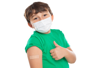 Child kid with plaster after Coronavirus vaccination wearing face mask against Corona Virus showing...