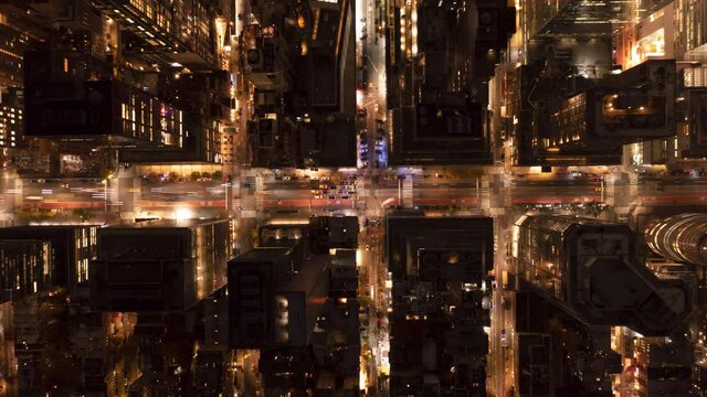 Aerial birds eye overhead top down view of traffic in streets of city. Night hyperlapse of moving vehicles. Manhattan, New York City, USA