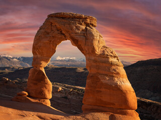 delicate arch in Arches National Park with clouds and moon - obrazy, fototapety, plakaty