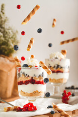 Joghurt dessert with whipped cream and fruits levitating objects