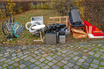 Pile of home bulky waste prepared for pickup at the street in German city.