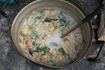 Curry banana blossom with pork (Northern Thai Food) is cooking in countryside, Thailand