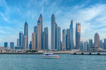 Fototapeta premium Scenic view of Dubai Marina Skyscrapers with big boat, Skyline, View from Palm Beach, United Arab Emirates
