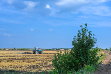 Fototapeta premium Tractor with equipment for harvesting. Agricultural machinery.