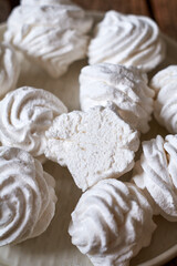 Russian homemade marshmallow, zefir, zephyr. Wooden background, side view, close up. 
