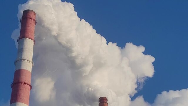 Industrial, ecology and environmental pollution. The smoke from the chimney of the industrial plant.