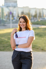 fashionable girl walks around the city of Minsk. The inscription on the T-shirt 