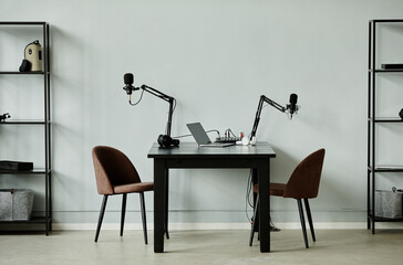 Minimal background image of podcast recording studio with two chairs, copy space