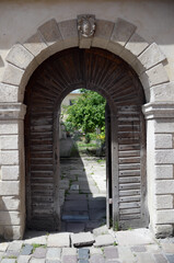 Fototapeta na wymiar Arched entrance, ancient architecture and antique doors