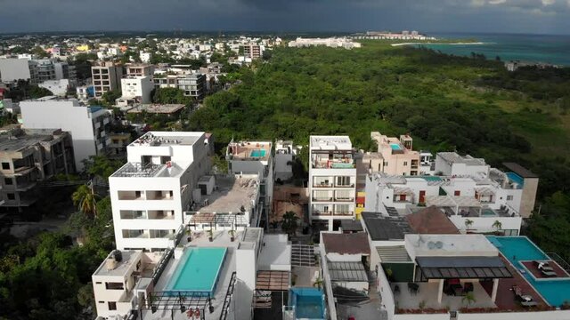 Flying Around a Rooftop pool in a Small Caribbean Town at Sunrise. High quality FullHD footage