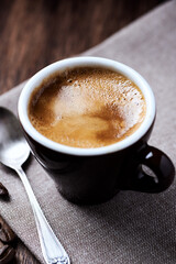 Cup of coffee on dark background. Close up.