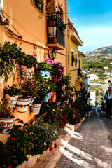 Narrow street and colorful facades of Polop village