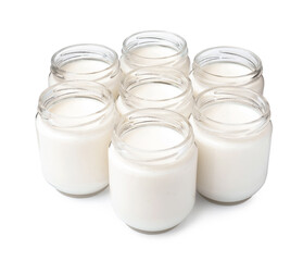 Glass jars with delicious homemade yogurt on white background