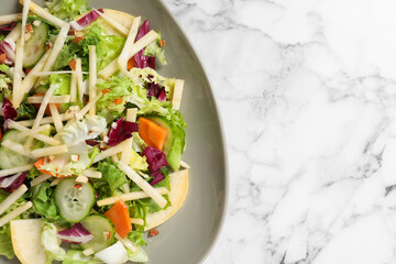 Delicious turnip salad served on white marble table, top view. Space for text