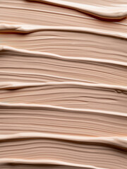 Aesthetic texture of nude liquid foundation. Bb-cream or beige liquid foundation, natural cosmetic for female face makeup. Abstract background brush strokes of beige facial tinted cream. Nude paint