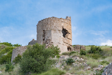 Fototapeta na wymiar View tower of Chembalo fortress. Medieval architecture monument, landmark. Ruined stone Genoese fortress in Balaclava in Crimea