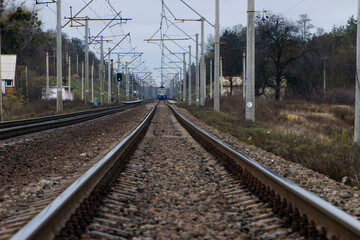 Fototapeta premium train, electric locomotive. railroad station. the railway goes into the distance, the rails are sleepers. branch of the high-speed railway. concept of travel, business trip, tourism.