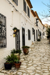 Narrow street and typical facades of Polop village