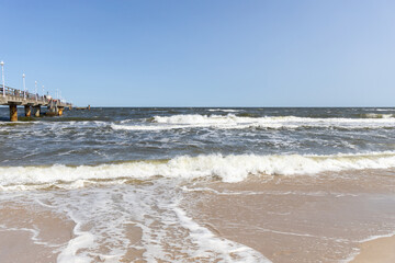 The waves in the seaside resort of Zinnowitz on the island of Usedom surround the great pier - obrazy, fototapety, plakaty